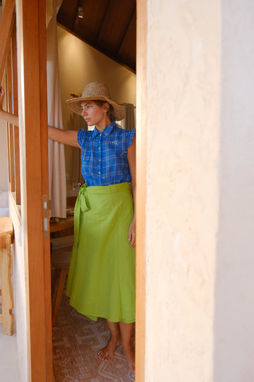 Presenting the Indigo Mary Oliver Top, a beautiful collaboration between Audrey E Leary and World of Crow. Featuring a classic indigo hue with jamdani checks and dot motifs, it is designed with a collared neckline and ruffled details. Made from lightweight, soft fabric, this top offers a relaxed fit and flowing silhouette for everyday comfort and style